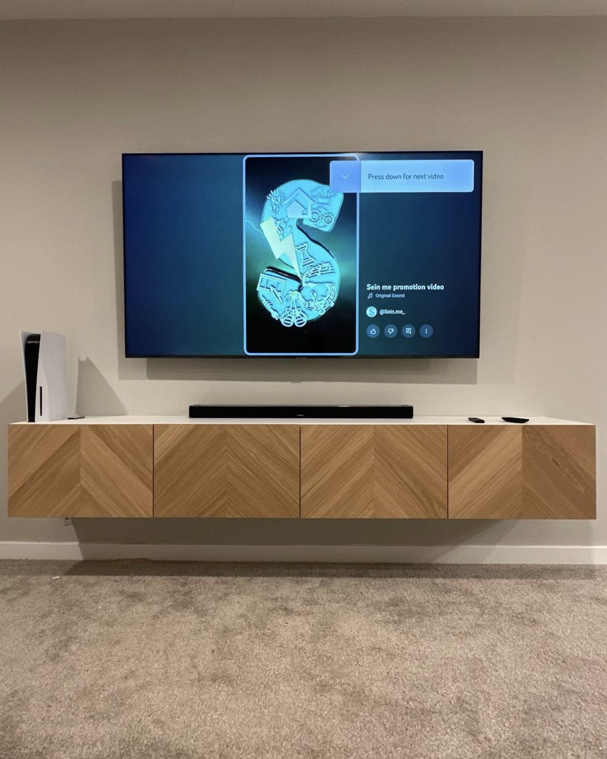 The Chevron, chevron-pattern wood accent panel with mounted TV by SEIN ME