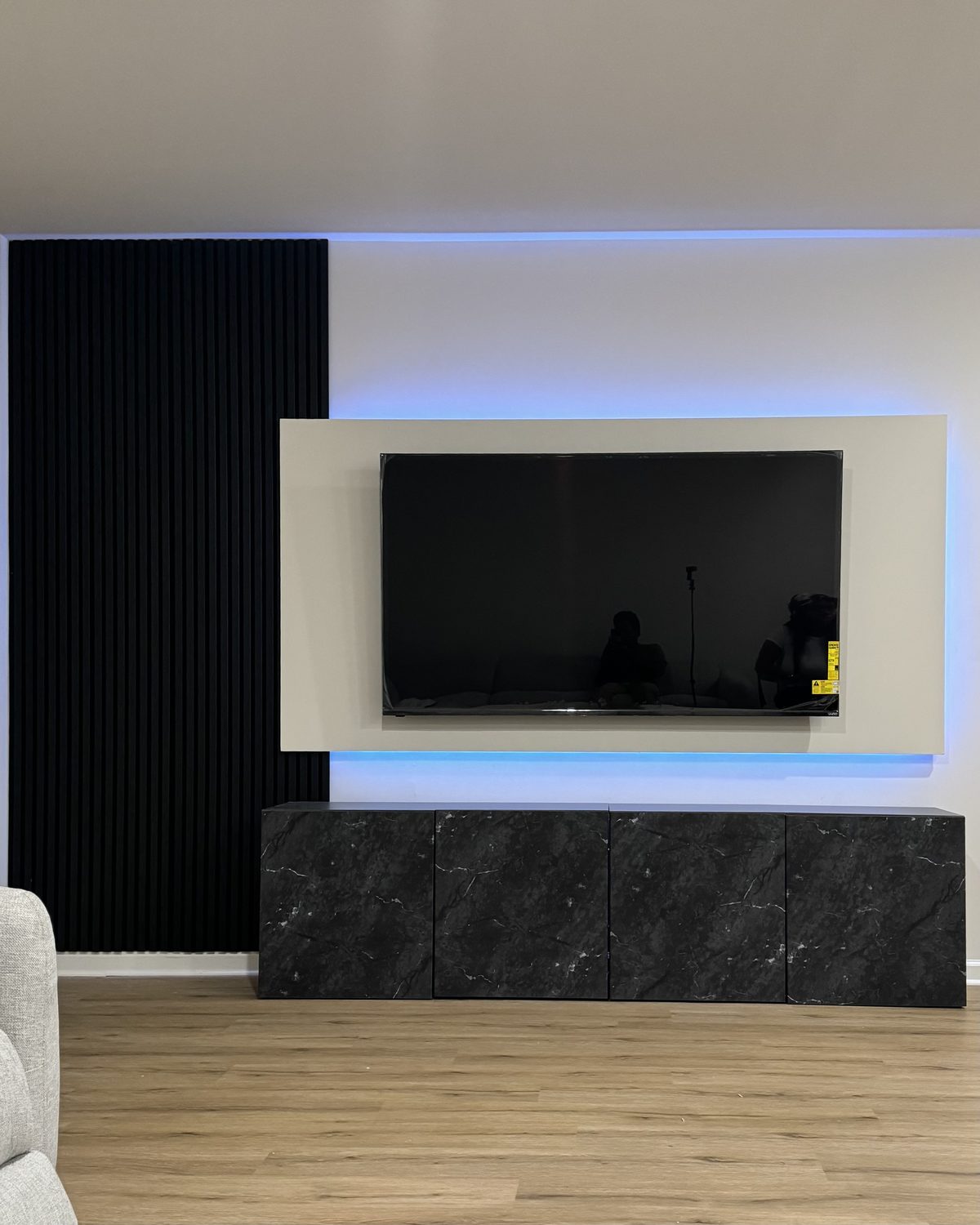 The Floating Frame: white marble look TV frame with LED backlight and black slat accent, a renter-friendly SEIN design