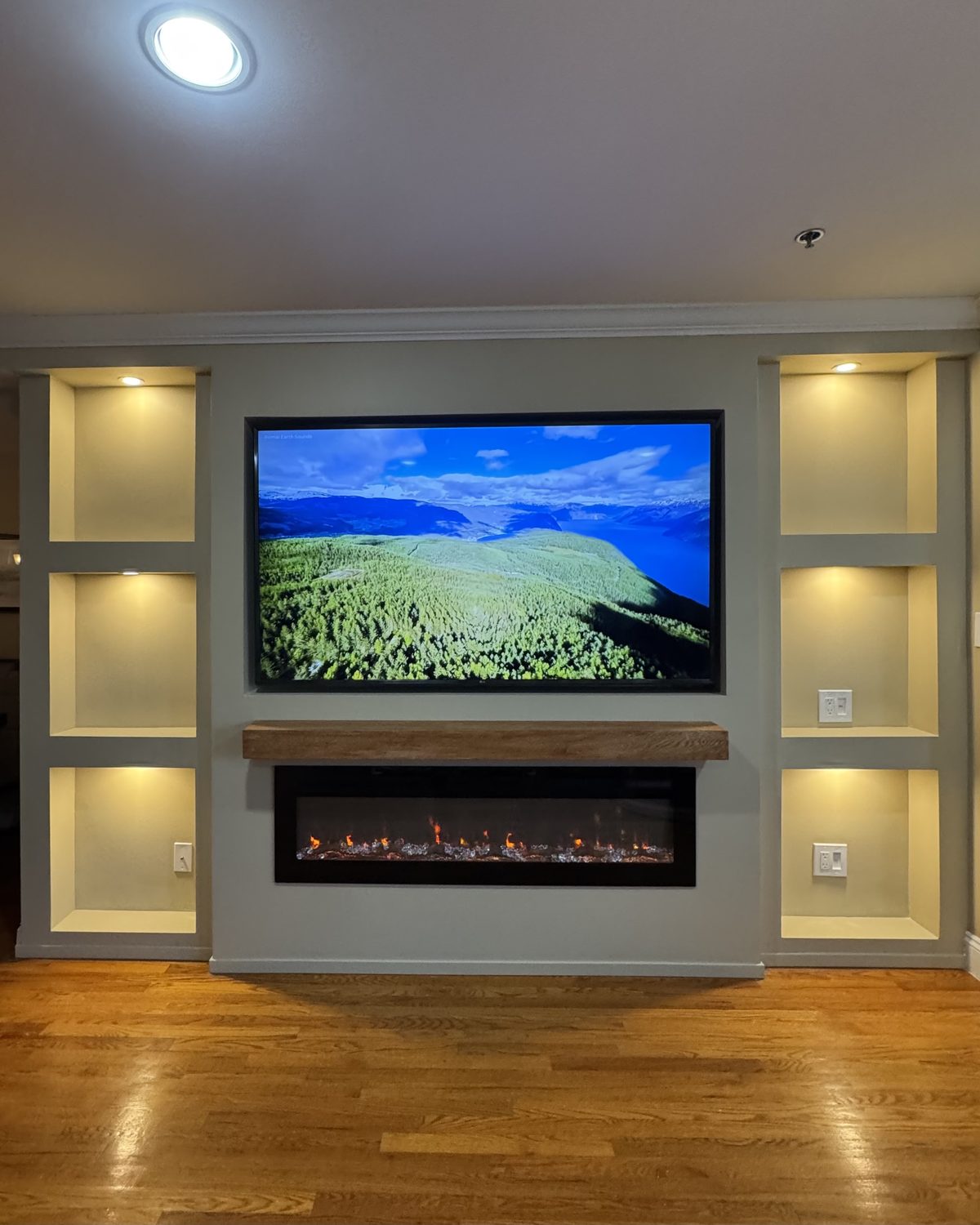 The Hearth: Full architectural built-in with lit side cubbies. The flagship, by SEIN ME