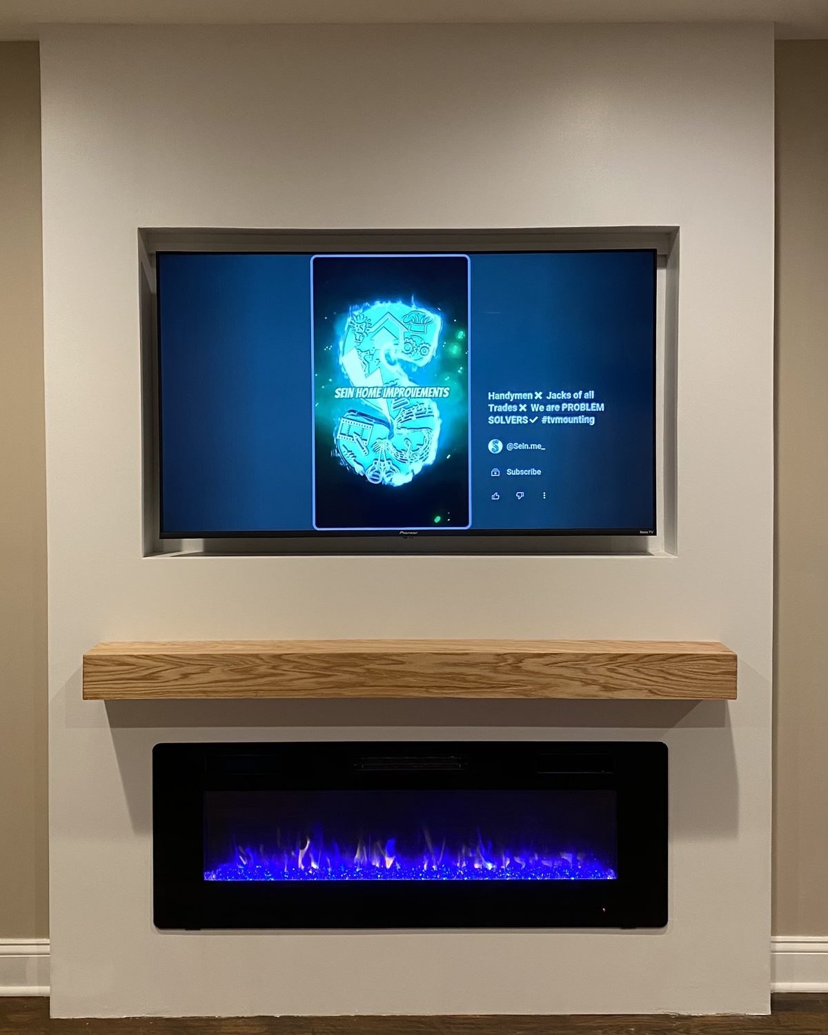 The Inset: Soft sage wall with deep recessed TV pocket and a solid wood mantel, by SEIN ME